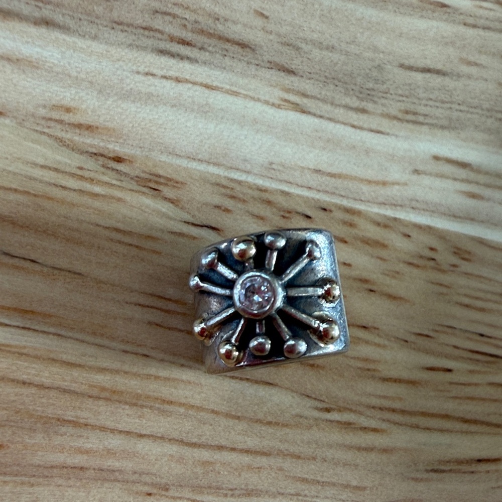 Retired Pandora Starburst Charm with 14k gold, sterling silver, and clear CZ.